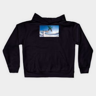 Snowboarder jumping against blue sky Kids Hoodie